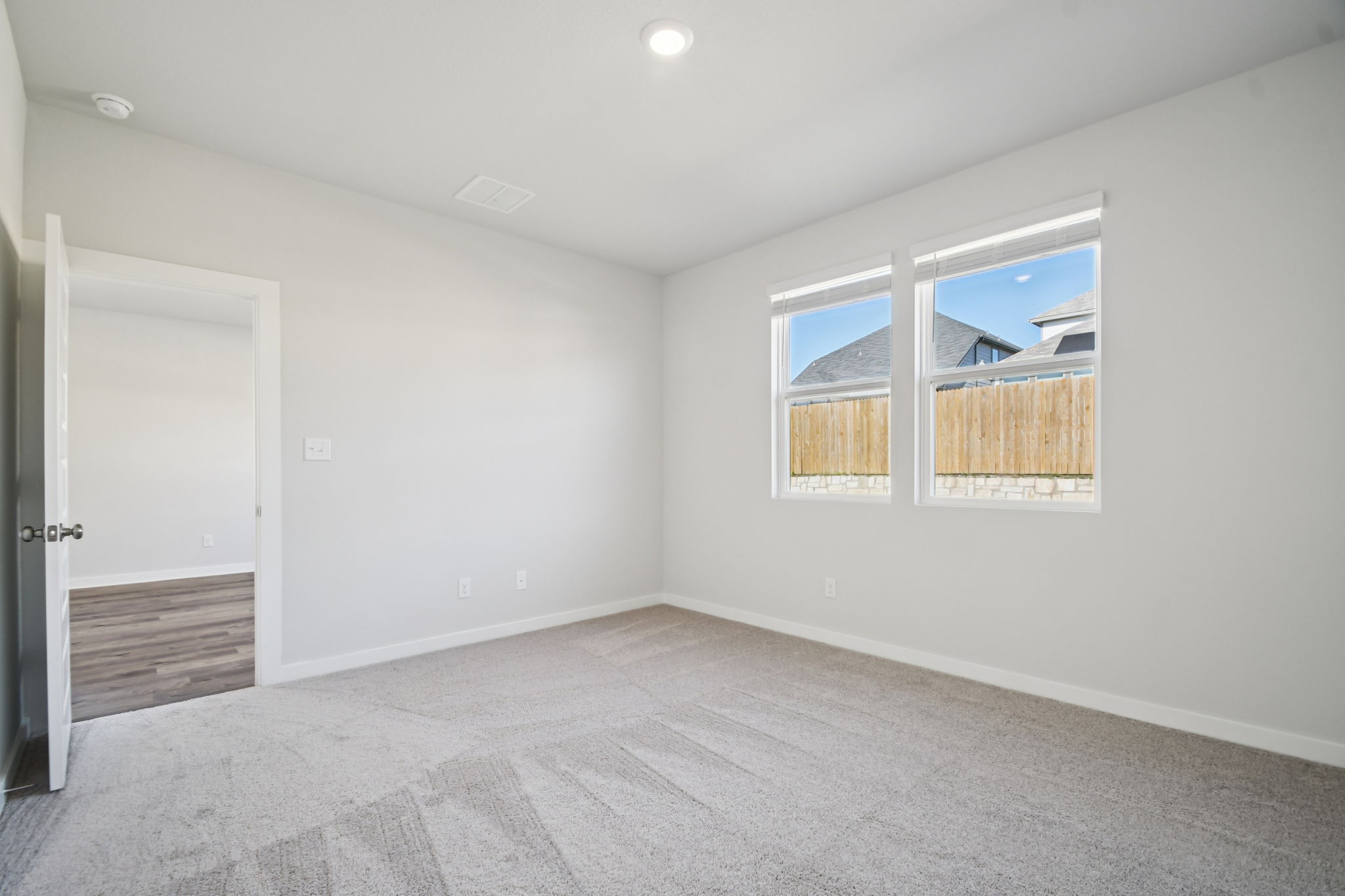 A room with a window and a door.