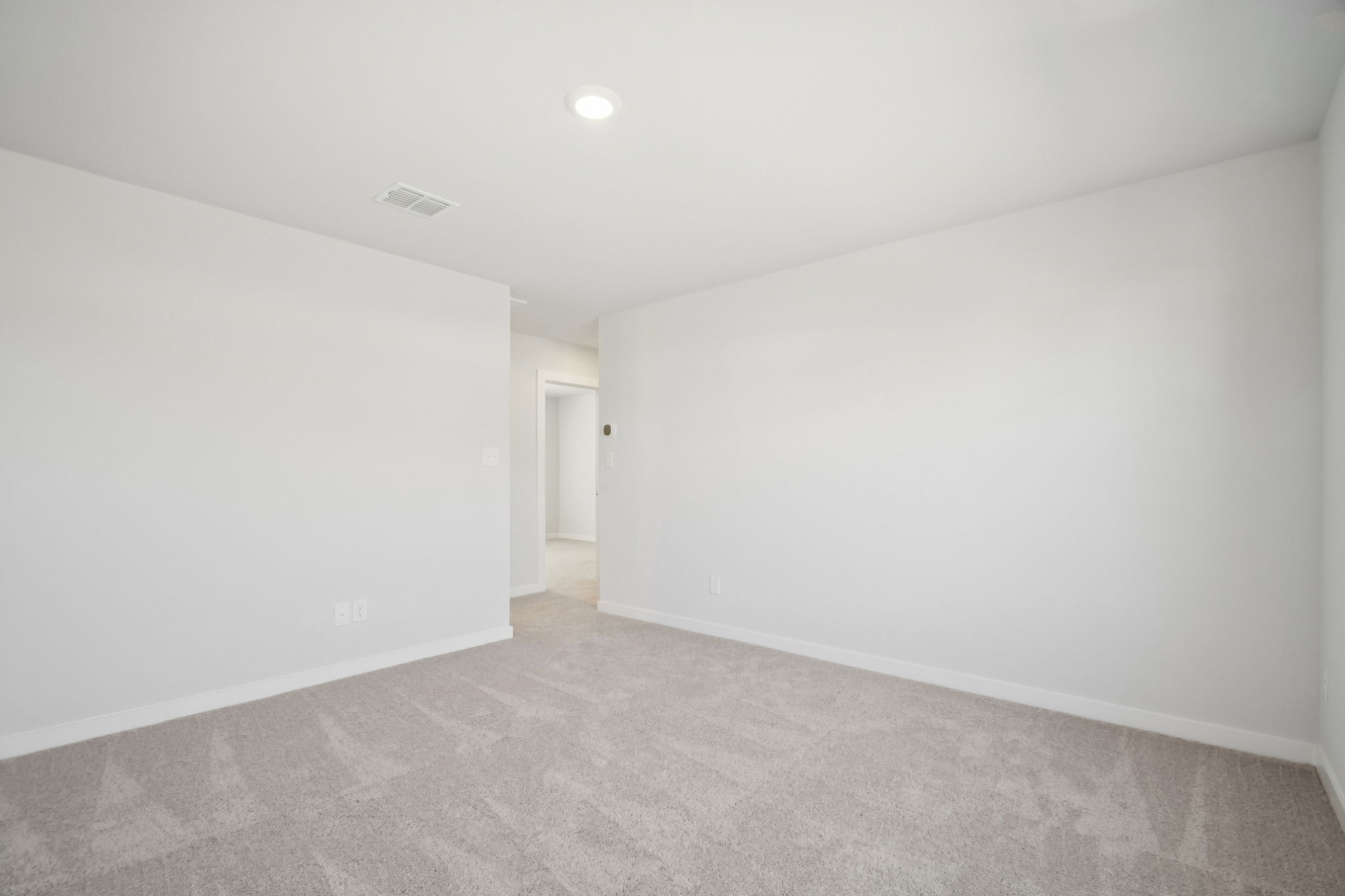 A hallway with white walls.