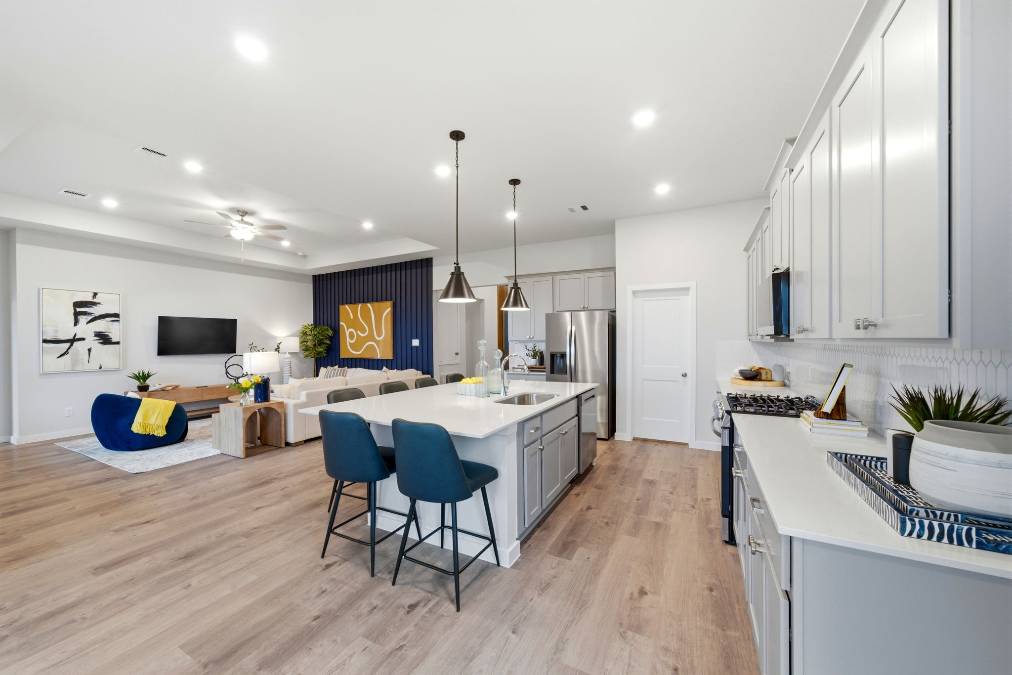 A kitchen with a bar and chairs.