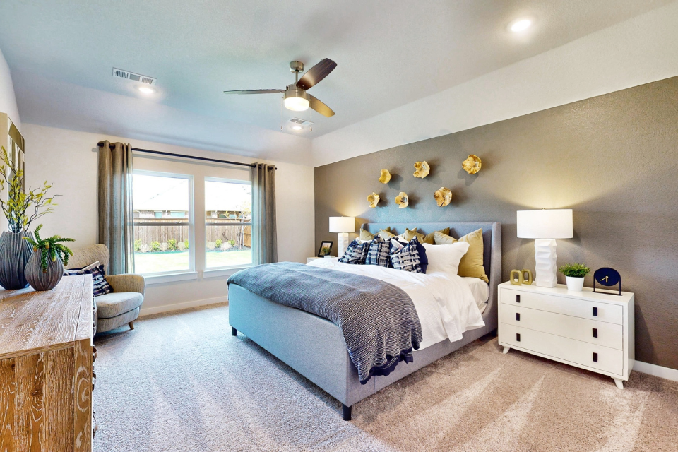 A bedroom with a bed and a chair.