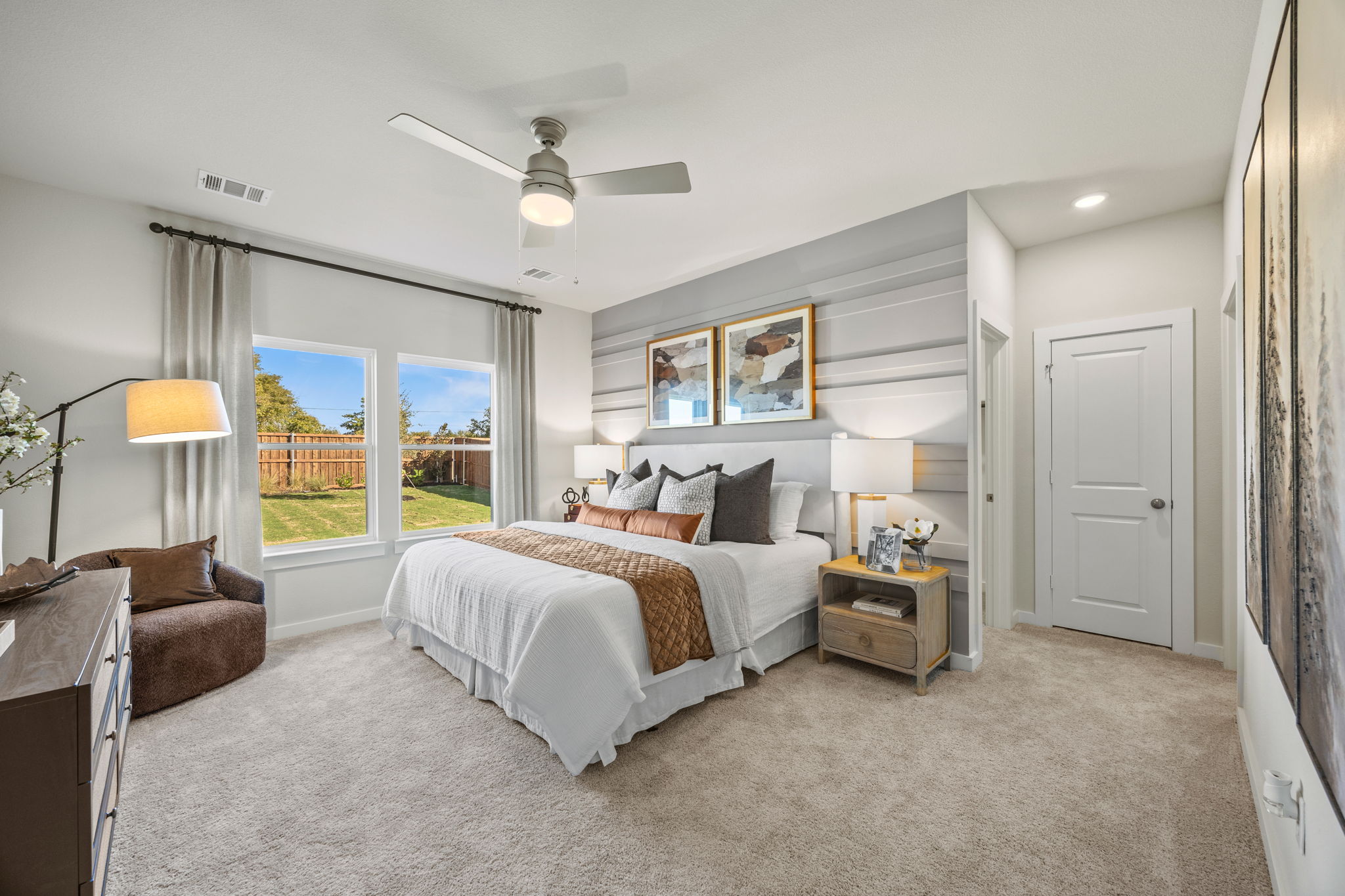 A bedroom with a large window.