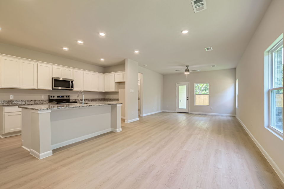 A large kitchen with white cabinets.