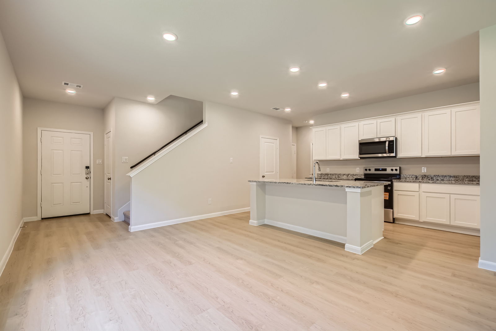 A large kitchen with white cabinets.