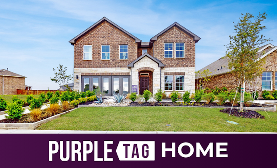 A brick house with a lawn.