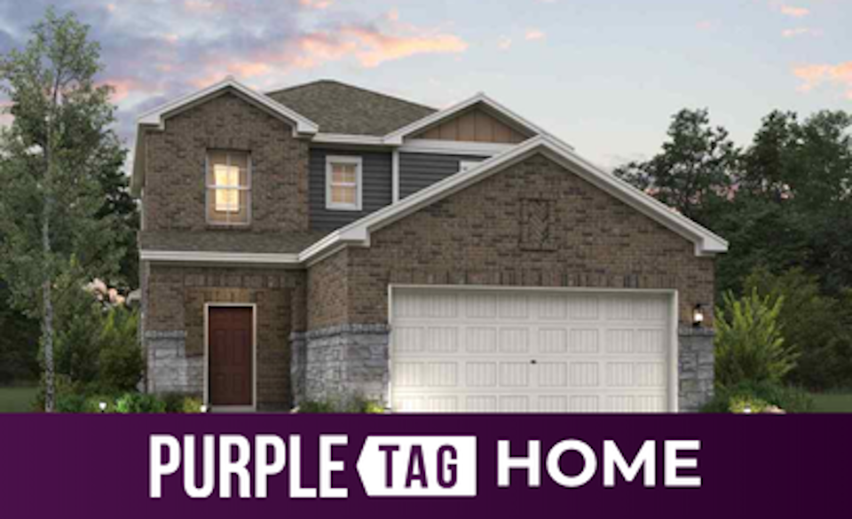 A house with a garage and trees.