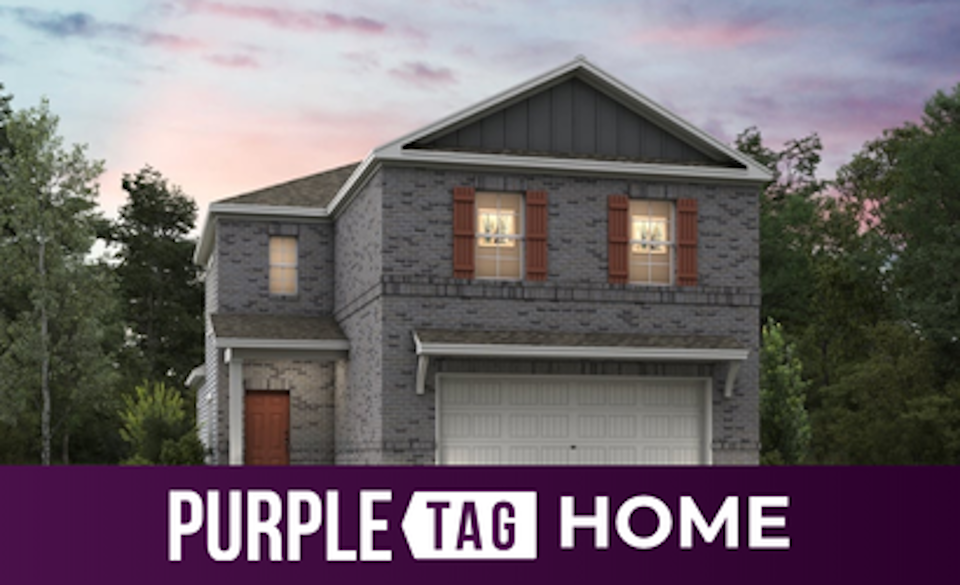 A house with a garage and trees.