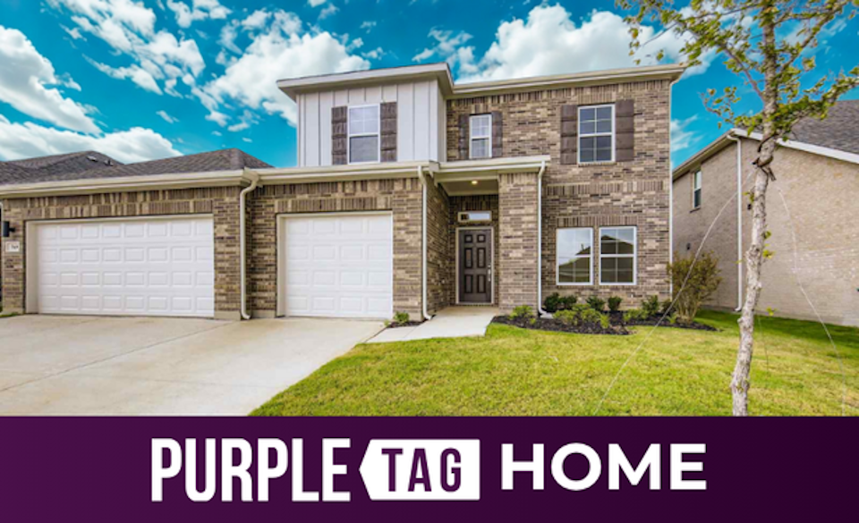 A house with garages and a lawn.