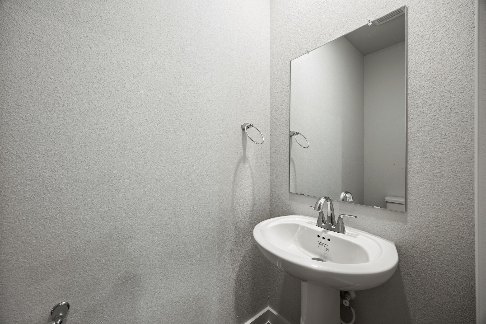 A bathroom with a mirror and sink.