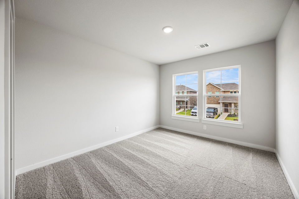 A room with a window and a carpet.