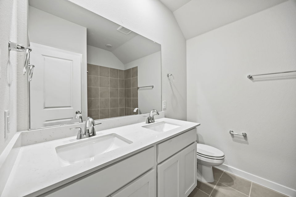 A bathroom with a large mirror.