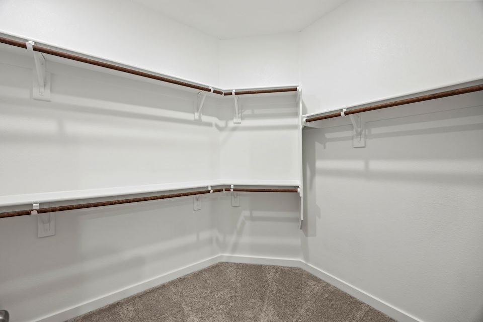 A white wall with a metal railing.