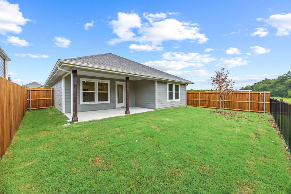 A house with a fence and grass.