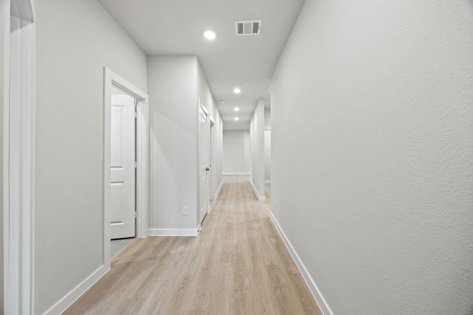 A long hallway with white walls.