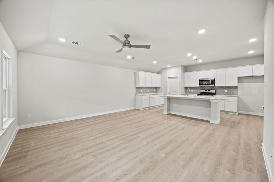 A large kitchen with white cabinets.