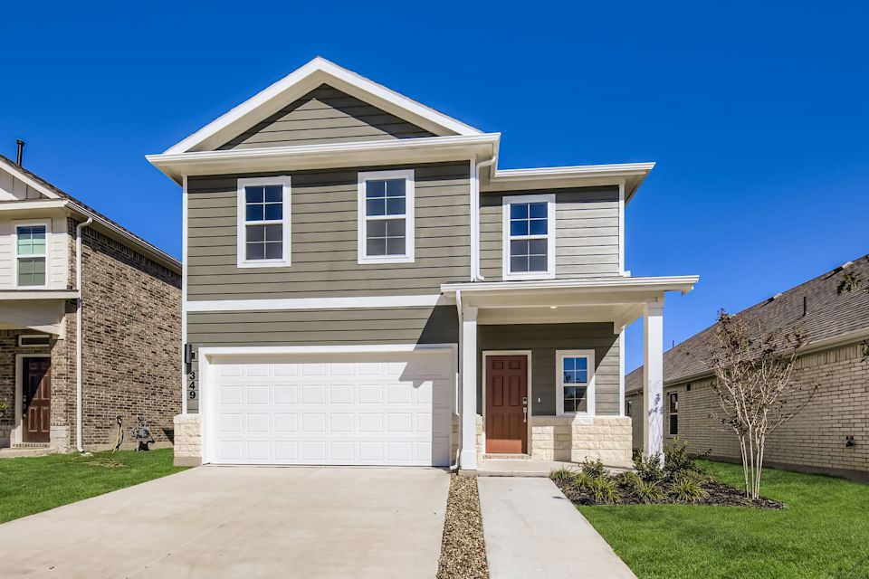 A white house with a garage.
