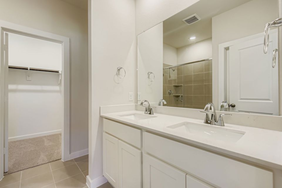 A bathroom with a large mirror.