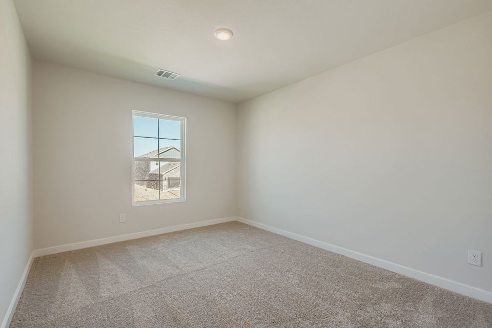 A room with a window and a carpet.
