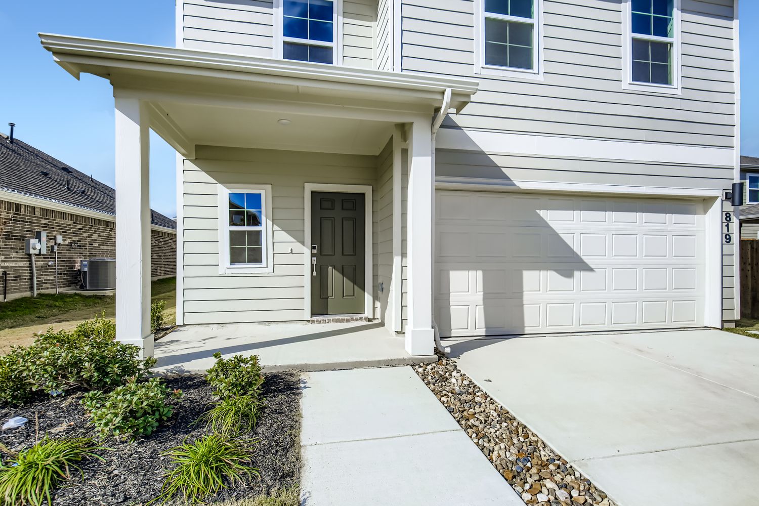 A white house with a garage.