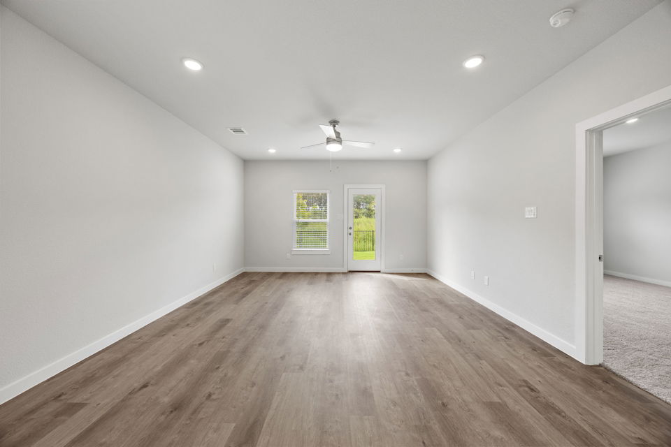 A room with a wood floor and a wood floor.