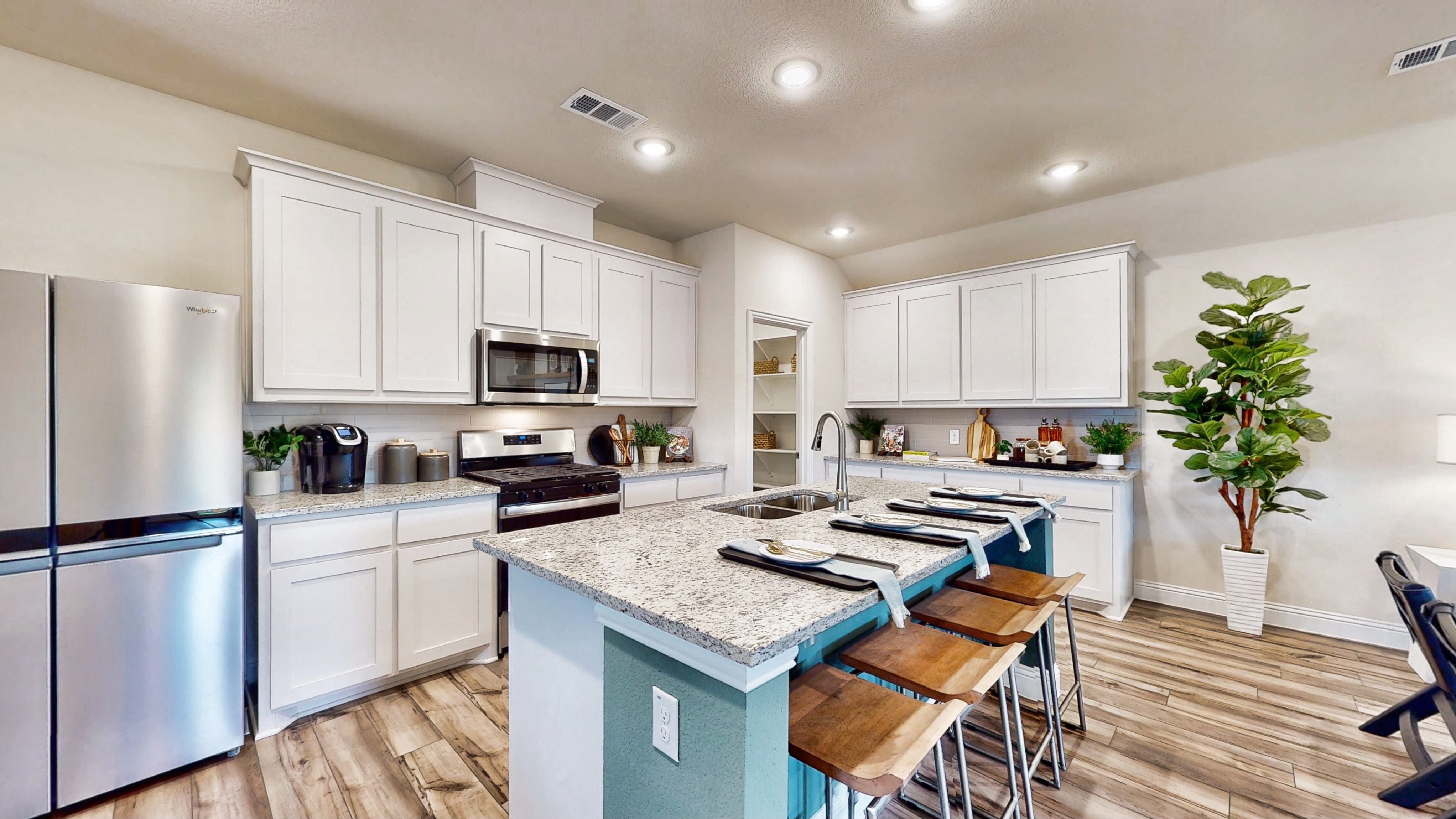A kitchen with white cabinets.