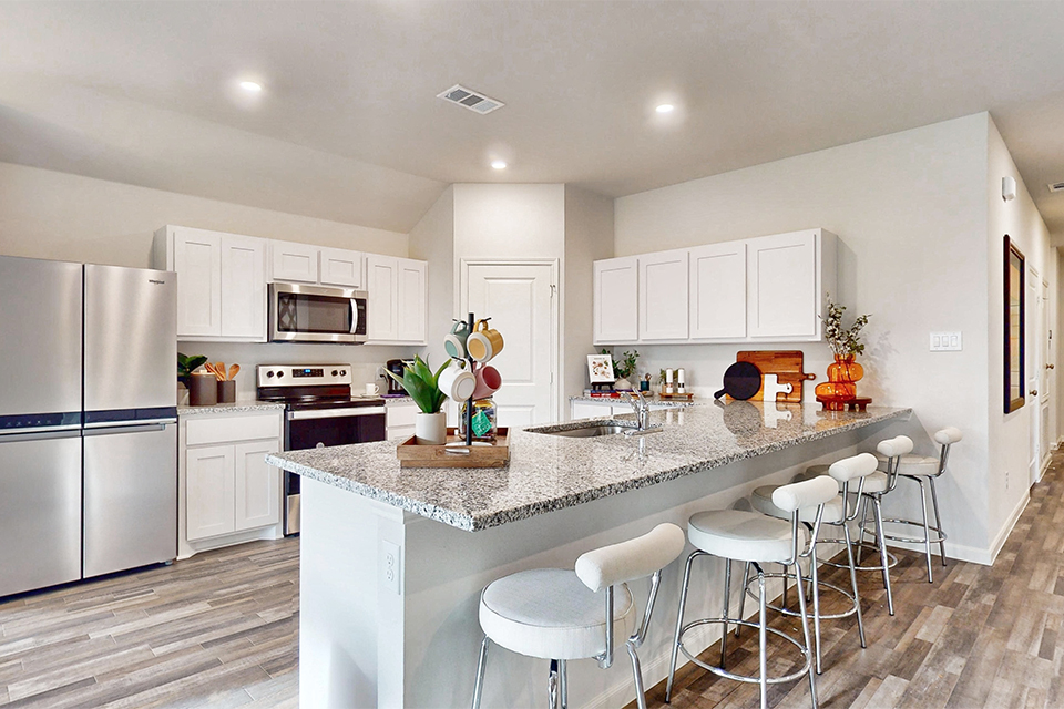 A kitchen with white cabinets.