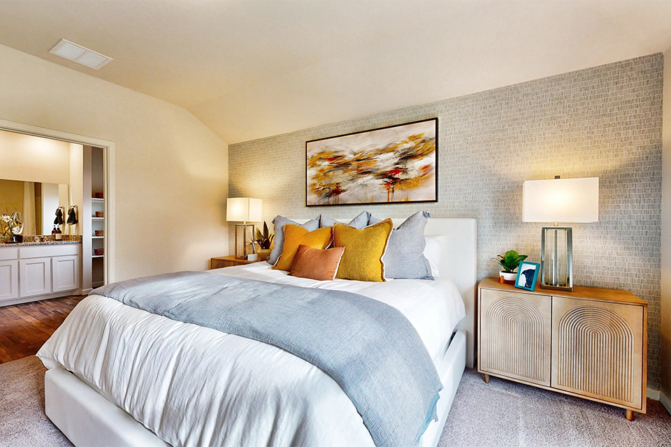 A bed with a white bed spread.