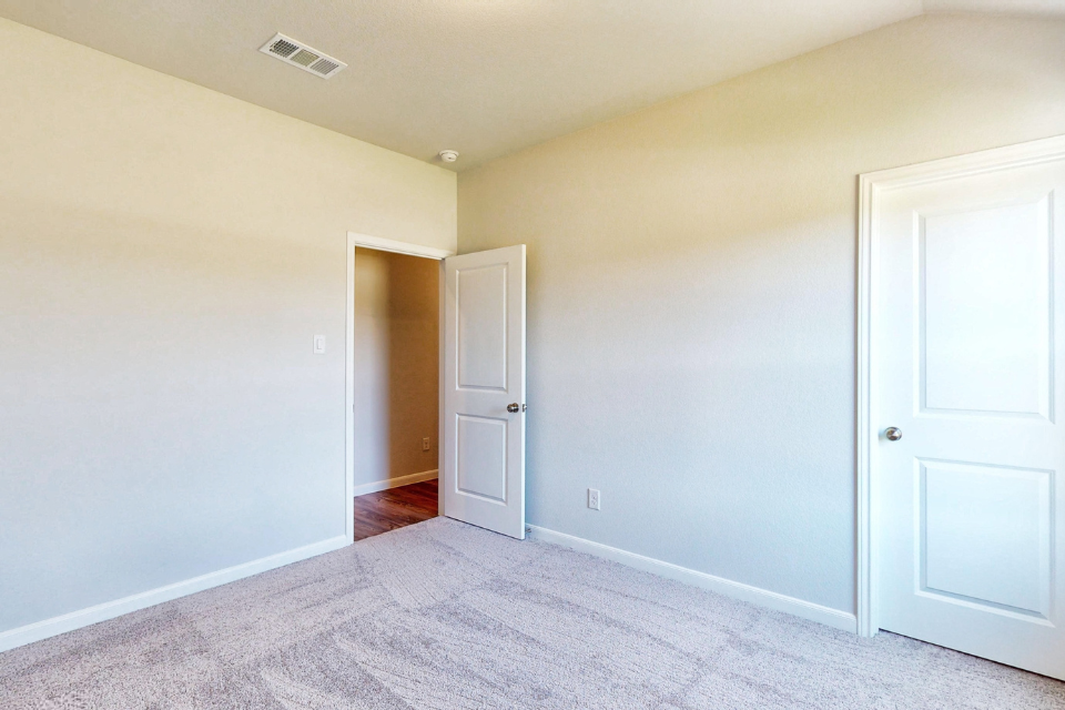 A hallway with white doors.