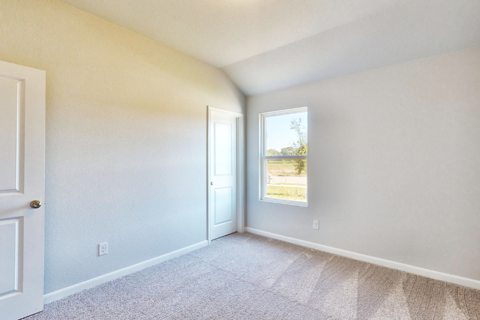 A room with a window and a door.