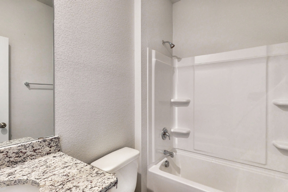 A bathroom with a marble countertop.