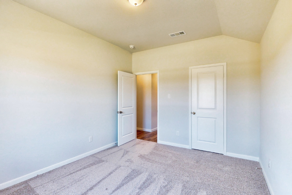 A hallway with white doors.