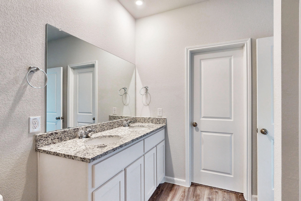 A bathroom with a marble countertop.