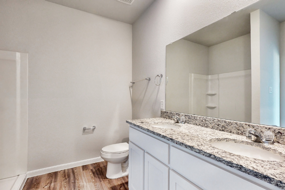 A bathroom with a large mirror.