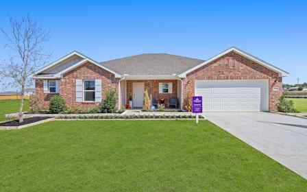 A brick house with a lawn.