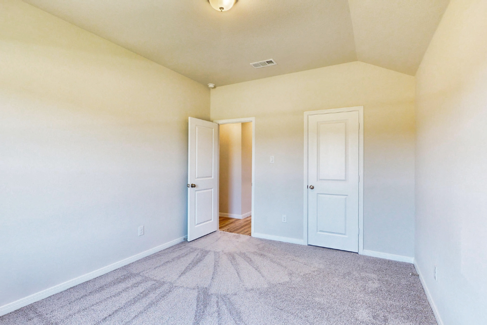 A hallway with white doors.