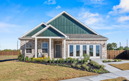 A house with a fence and grass.