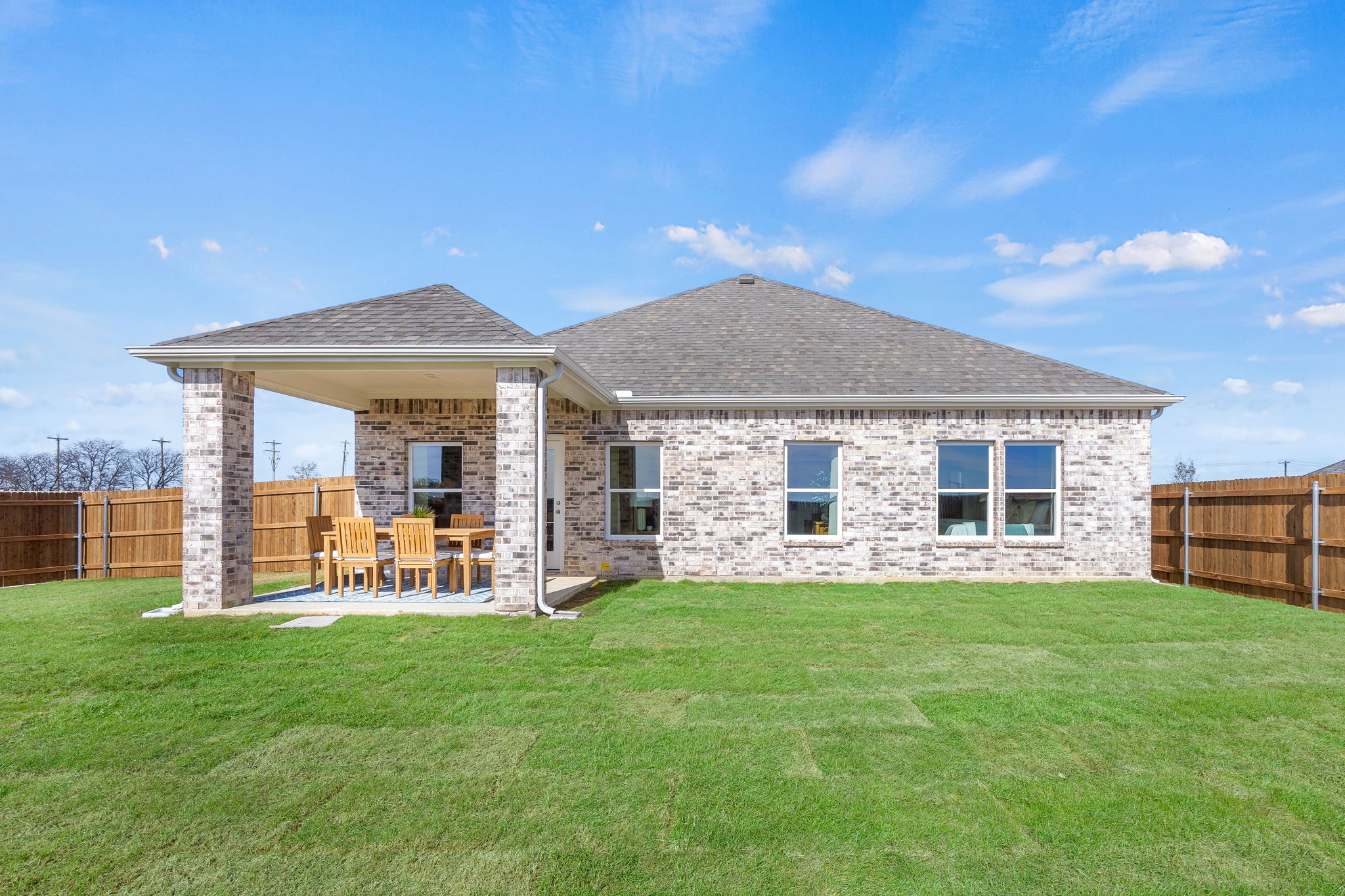 A house with a lawn and chairs.