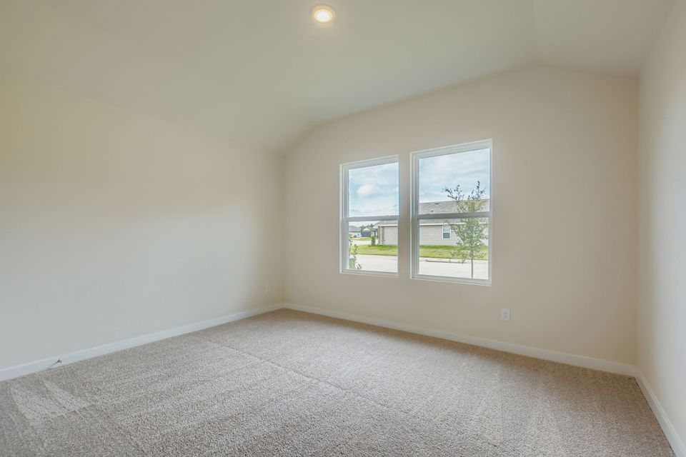 A room with a window and carpet.