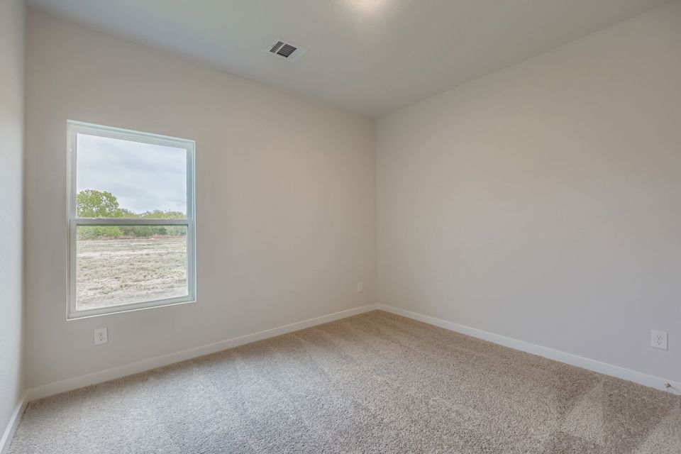 A room with a window and a carpet.