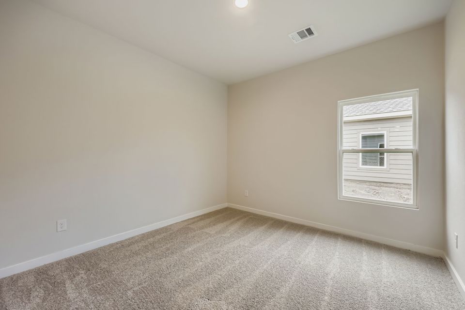 A room with a window and carpet.