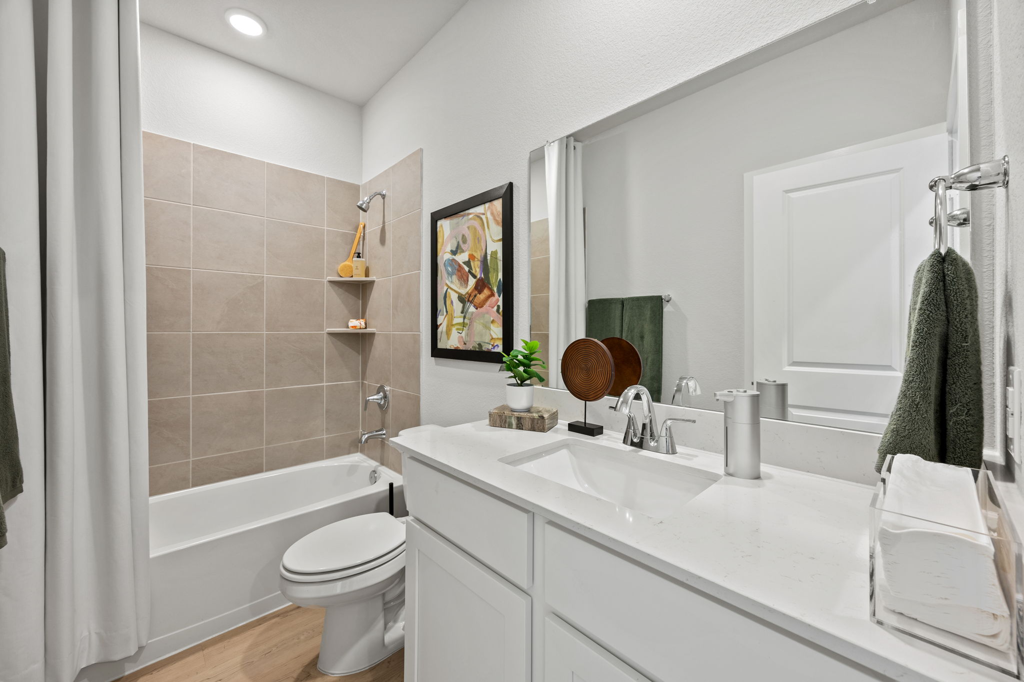 A bathroom with a tub sink and toilet.