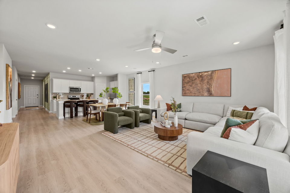 A large living room with a wood floor.