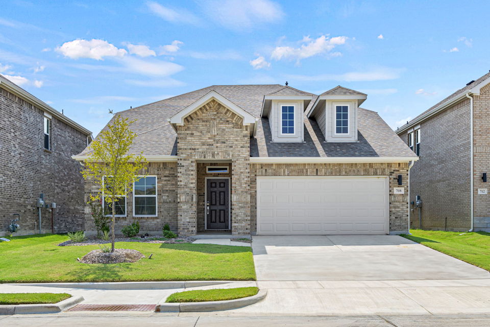 A large house with a driveway.