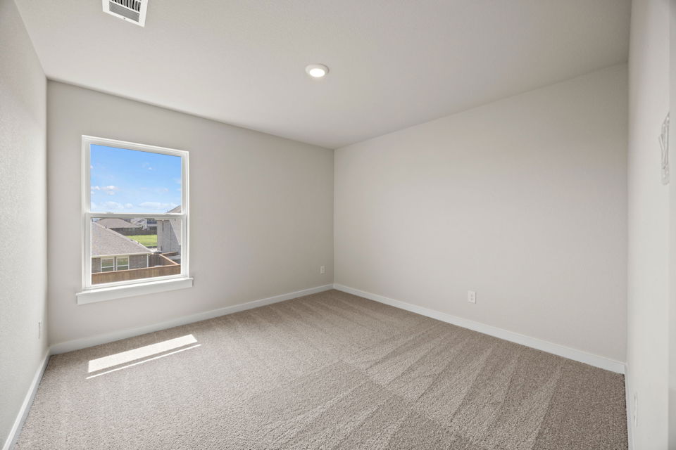 A room with a window and a carpet.