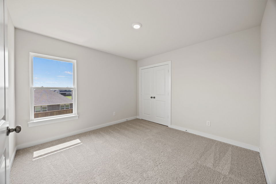 A room with white doors and a window.