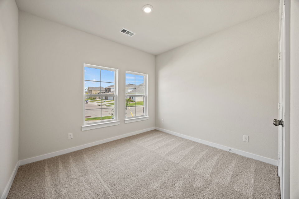 A room with a window and carpet.