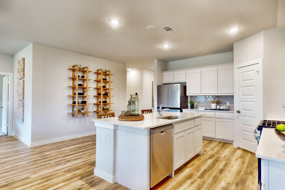 A kitchen with white cabinets.