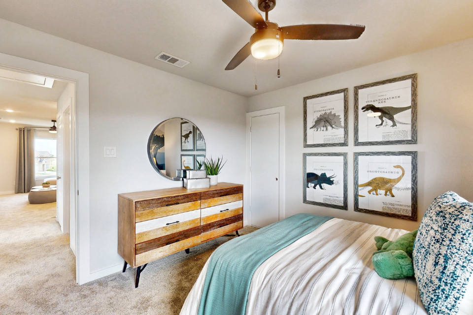 A bedroom with a bed and a bench.