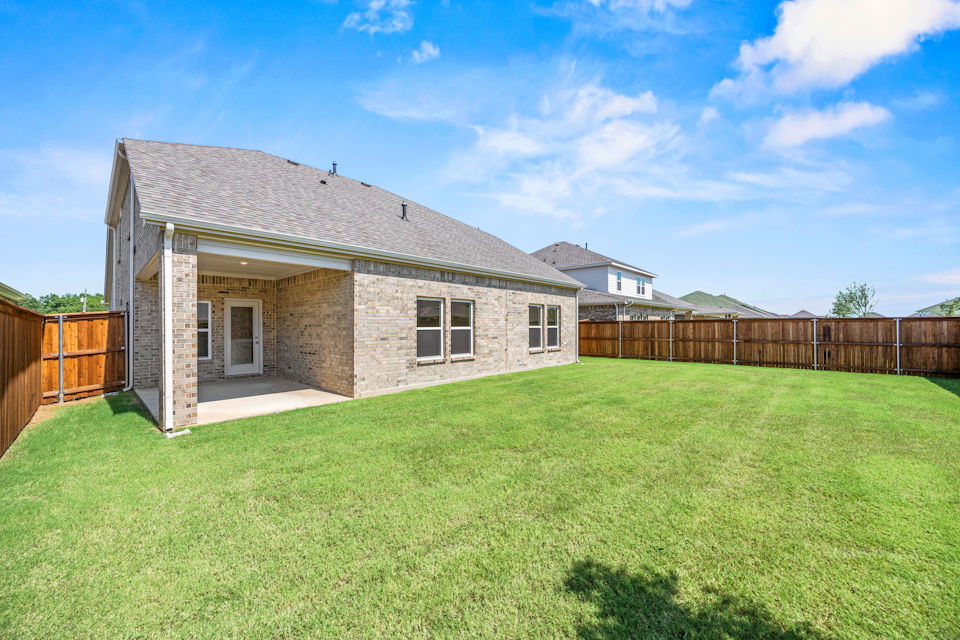 A house with a fence and grass.