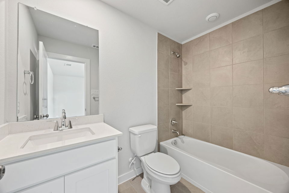 A bathroom with a tub toilet and sink.