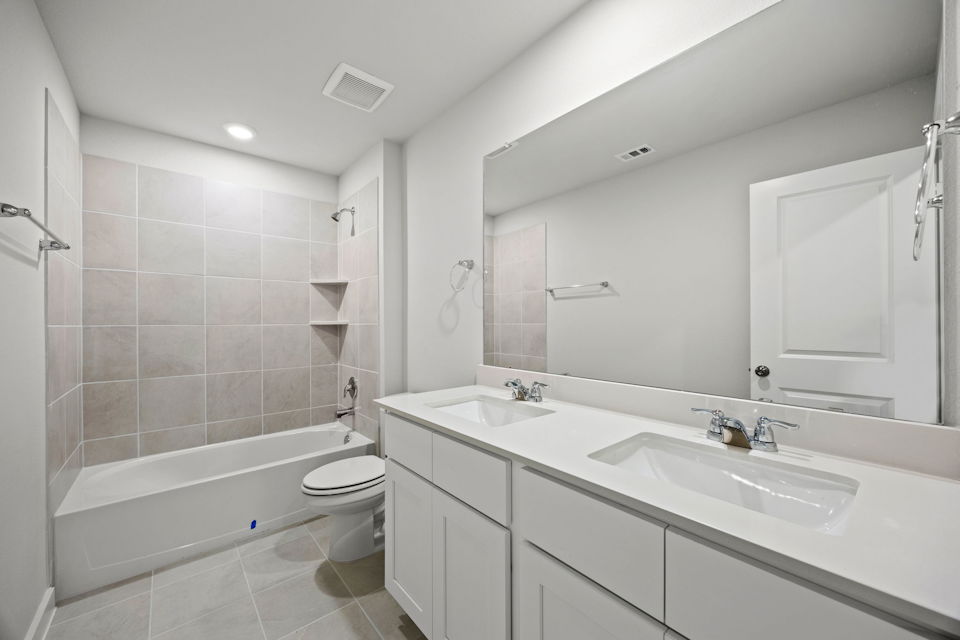 A bathroom with a tub sink and toilet.